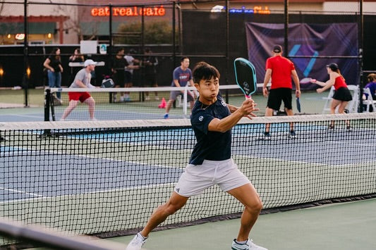 Real young pickleball player competing on court