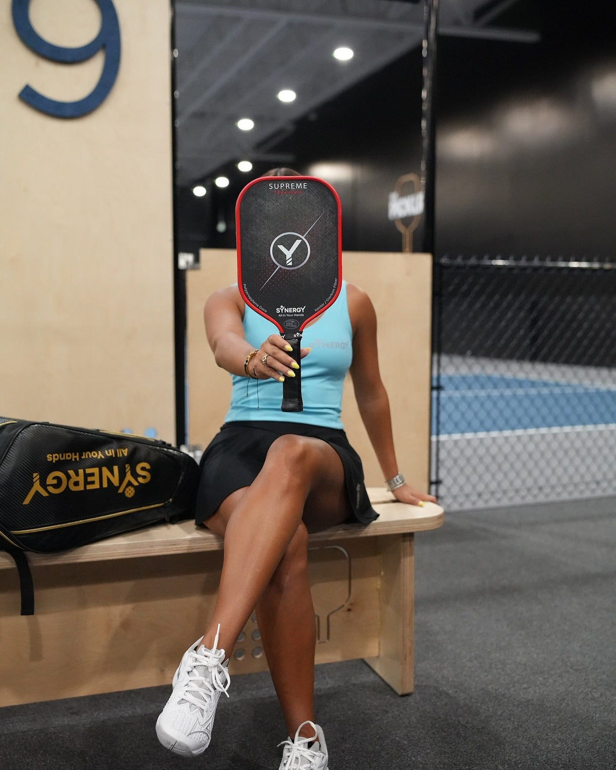 Real player with a Synergy Supreme paddle courtside